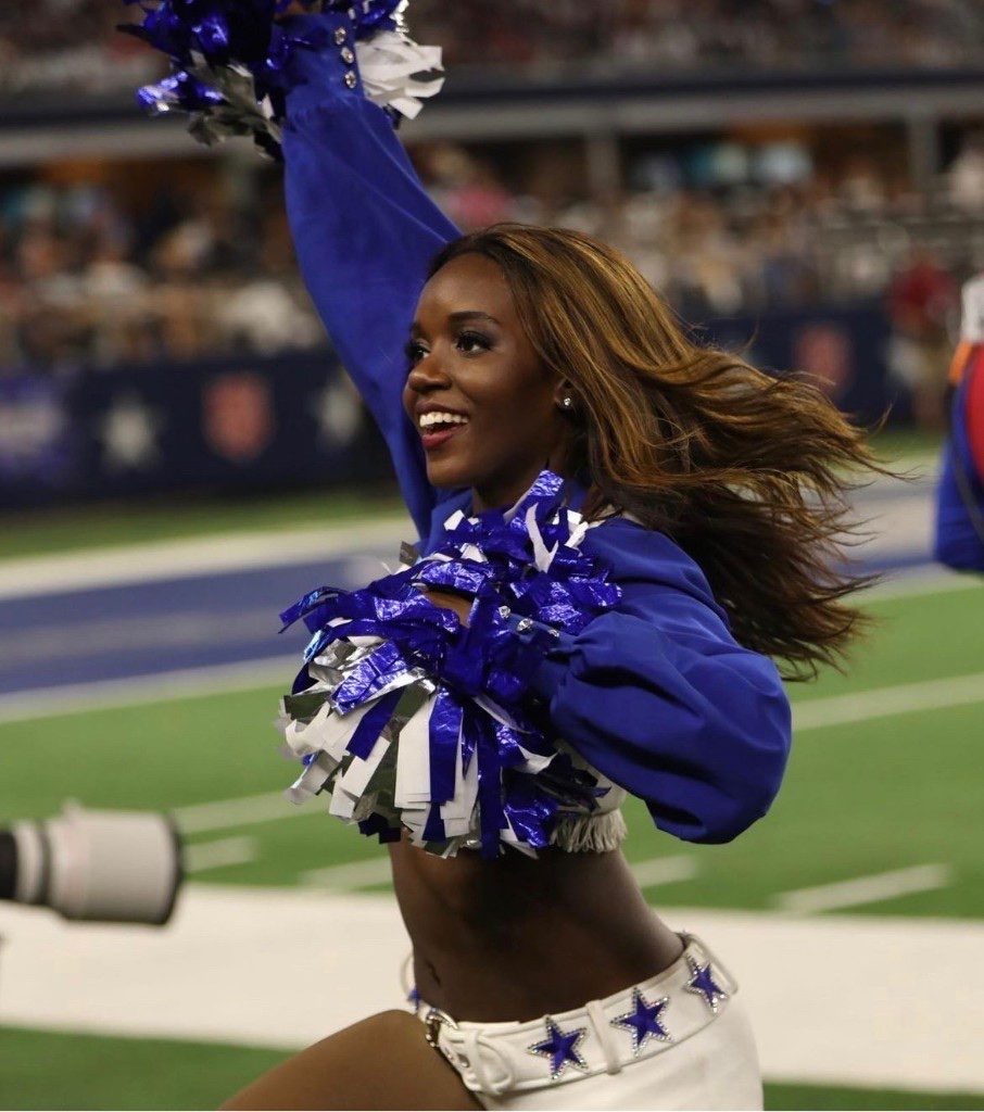 Dallas Cowboys Cheerleader with pom-poms in the stadium