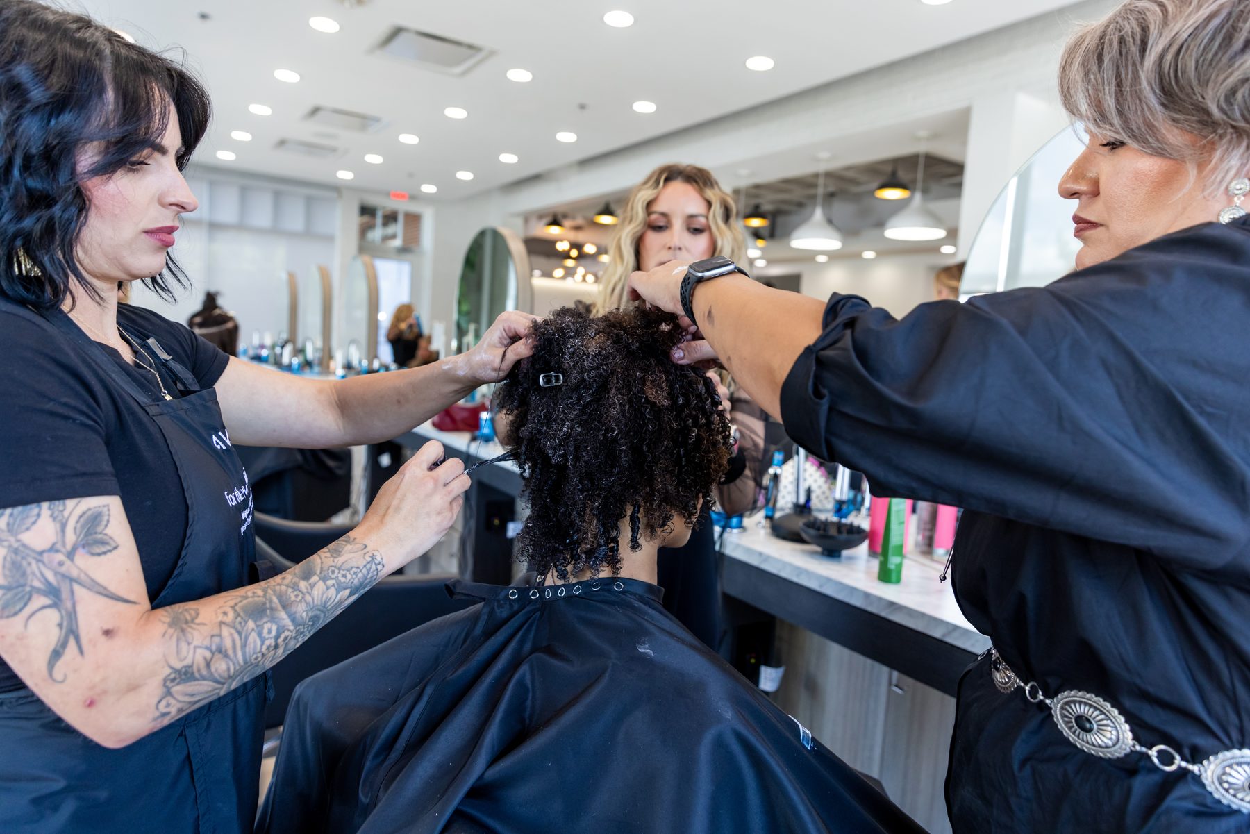 Stylists shaping curls during a DCC makeover at Rose Style Studio