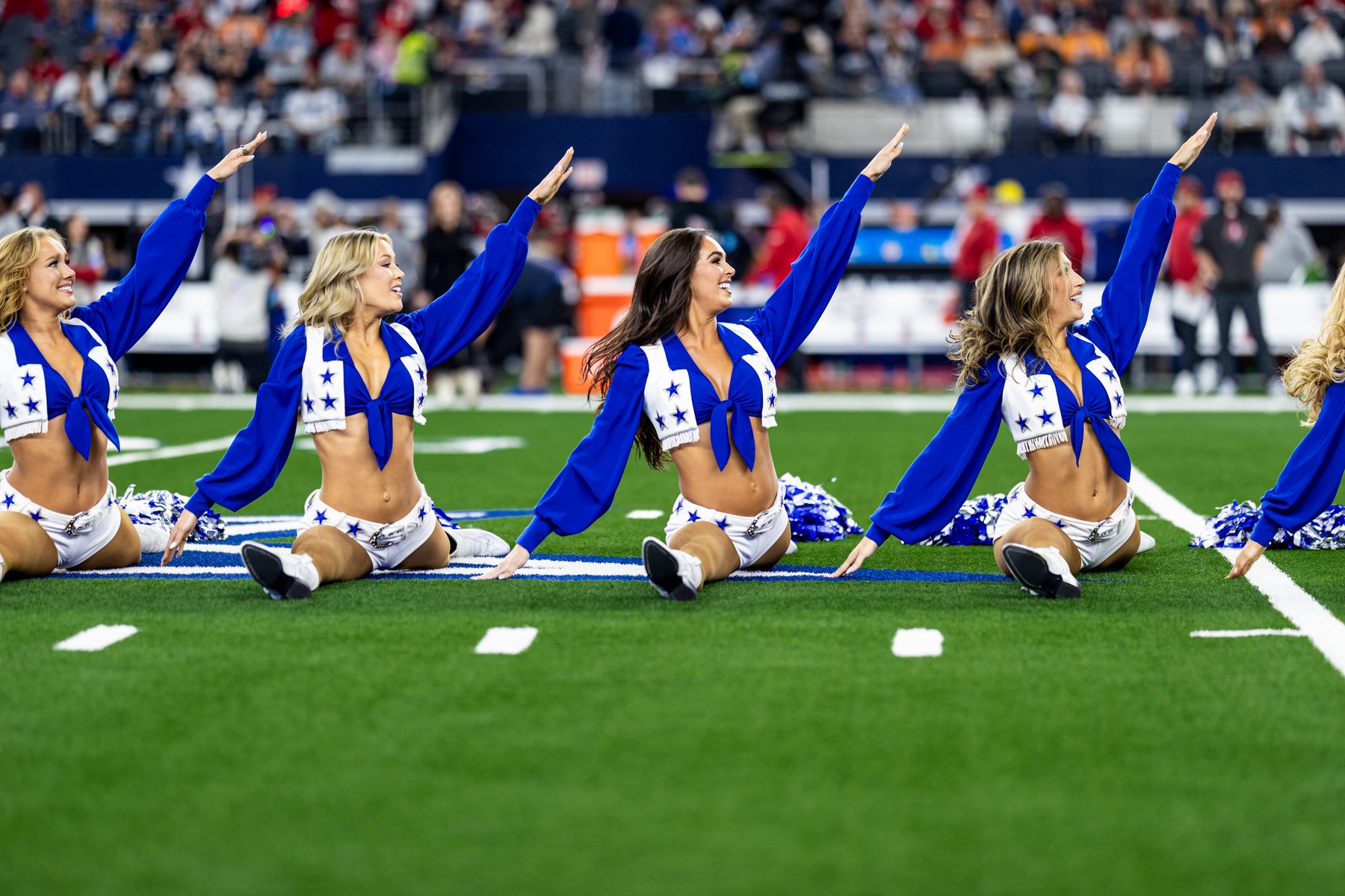 Dallas Cowboys Cheerleaders in splits on the stadium field